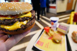A McDonald's Double Quarter Pounder is shown with the new fresh beef Tuesday, March 6, 2018, in Atlanta. McDonald's is offering fresh beef rather than frozen patties in some burgers at thousands of restaurants, a switch it first announced about a year ago as it works to appeal to customers who want fresher foods. (AP Photo/Mike Stewart)
