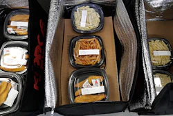 This May 10, 2018 photo shows catered lunches packed in containers to deliver to Kipling Elementary School in Highland Park, Ill. Food-delivery services are remaking school lunch. Many parents still make their kids' lunch, of course, or sign up for a hot-lunch program through school. But others are ordering from companies that deliver meals to home or school. Kiddos Catering in Chicago has come up with a different twist: providing restaurant meals to schools that contract with it. (AP Photo/Nam Y. Huh)