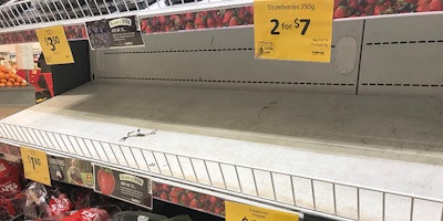 In this Sept. 14, 2018, photo, empty shelves, normally stocked with strawberry punnets, are seen at a Coles Supermarket in Brisbane. Public fears about sewing needles concealed inside strawberries on supermarket shelves have spread across Australia and New Zealand as growers turn to metal detectors and the Australian government launches an investigation to restore confidence in the popular fruit.(Dan Peled/AAP Image via AP)