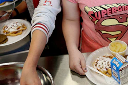 FILE - In this Friday, May 19, 2017 file photo, students line up for lunch at a middle school in Sandy, Utah. On Thursday, Dec. 6, 2018, the U.S. Department of Agriculture announced the scaling back contested school lunch standards implemented under the Obama administration, including one that required only whole grains be served. (Laura Seitz/The Deseret News via AP)