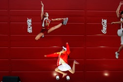 FILE - In this Aug. 20, 2008 file photo, a young girl mimics the pose of a Chinese Olympic athletes depicted in Coca-Cola advertising, at the Olympic green in Beijing. The International Life Science Institute, a group funded by the food industry, undermined China’s efforts to keep obesity rates in check by overemphasizing the importance of physical activity rather than dietary restrictions, according to a new paper. The group sponsored obesity conferences on exercise science with speakers including Coke-funded researchers and a Coke executive. ILSI says it does not profess to have been perfect, but that it has adopted stricter guidelines. (AP Photo/Elizabeth Dalziel)