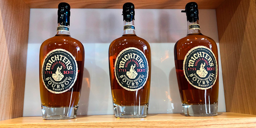 This Jan. 25, 2019 photo shows bottles of Michter's Bourbon displayed at the spirit maker’s new Fort Nelson Distillery in Louisville, Ky. Whiskey makers are used to long waits, but restoration of an old building to make way for a new Kentucky distillery lasted longer than it takes most bourbon to age to maturity. The wait ends Thursday at Michter's, when the small producer of premium spirits shows off its new Fort Nelson Distillery in downtown Louisville. (AP Photo/Bruce Schreiner)