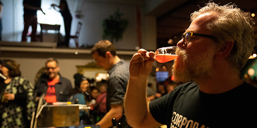 In this photo taken Wednesday, Feb. 20, 2019, historian Stefan Palsson observes the beer selection at a government-run monopoly liquor store in Reykjavik. Icelanders are celebrating the end, three decades ago, of a sobering dry spell in their country’s history. On Friday, March 1 the country toasts the anniversary of the lifting of a decades-long ban on beer with — what else? — a nationwide Beer Day. (AP Photo/Egill Bjarnason)