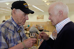 File - In this April 17, 2011 file photo, is John Shafer, right, chairman of Shafer Vineyards, talking about wine with David Rosenberg, left, a World War II veteran, during a lunch at the Veterans Home of California in Yountville, Calif. Northern California vintner and philanthropist John Shafer has died at the age of 94. He was part of a generation of vintners that transformed the sleepy Napa Valley into a region known the world over for its stellar wines. Shafer Vineyards announced Monday, March 4, 2019, that its founder died Saturday in Napa. (AP Photo/Eric Risberg, File)