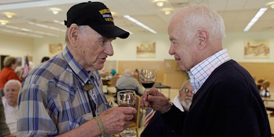 File - In this April 17, 2011 file photo, is John Shafer, right, chairman of Shafer Vineyards, talking about wine with David Rosenberg, left, a World War II veteran, during a lunch at the Veterans Home of California in Yountville, Calif. Northern California vintner and philanthropist John Shafer has died at the age of 94. He was part of a generation of vintners that transformed the sleepy Napa Valley into a region known the world over for its stellar wines. Shafer Vineyards announced Monday, March 4, 2019, that its founder died Saturday in Napa. (AP Photo/Eric Risberg, File)