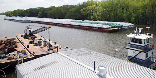 In this Tuesday, May 14, 2019 photo, barges already loaded with soy beans, potash or scrap steel await movement on the Mississippi River in St. Paul, Minn., as spring flooding interrupts shipments on the river. Historic Midwest flooding that began in March has left parts of the Mississippi River closed for business. (AP Photo/Jim Mone)