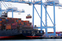 In this Nov. 4, 2019 photo, cargo cranes are used to take containers off of a Yang Ming Marine Transport Corporation boat at the Port of Tacoma in Tacoma, WA.