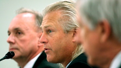In this Feb. 26, 2008 file photo, Bumble Bee Foods President and Chief Executive Officer Christopher Lischewski, center, flanked by Butterball President and Chief Executive Officer Keith Shoemaker, left, and Dole Food Company President and Chief Executive Officer David DeLorenzo, testifies on Capitol Hill in Washington.