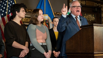 Minnesota Gov. Tim Walz speaks at a press conference at the State Capitol on Wednesday, Dec. 4, in St. Paul, MN. At his left were two teens, Will Gitler and Claire Hering, who spoke about being vaping addicts.