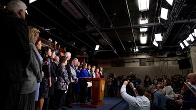 House Speaker Nancy Pelosi of Calif., accompanied by House Congress members, speaks at a news conference to discuss the United States Mexico Canada Agreement (USMCA) trade agreement on Tuesday, Dec. 10 on Capitol Hill in Washington.