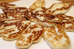 In this photo taken Wednesday Dec. 11, 2019, Cyprus' halloumi cheese is seen roasted on a plate at 'Riverland' farm in Kampia village near Nicosia, Cyprus. Cyprus' halloumi cheese, with a tradition dating back some five centuries, is the island nation's leading export. It's goat and sheep milk content makes it a hit with health-conscious cheese lovers in Europe and beyond. It's added appeal is that unlike other cheeses, it doesn't melt when heated up.