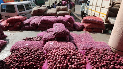 This Dec. 16 photo shows bags of onions lying at a market in Ahmadabad, India.