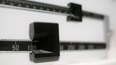 This April 3, 2018 photo shows a closeup of a beam scale in New York. A report released on Wednesday, Dec. 18, 2019 says nearly half of American adults will be obese within a decade and one-quarter will be severely so.