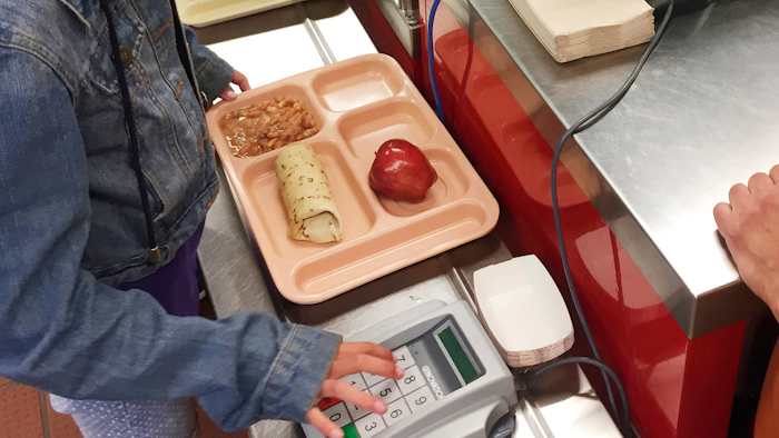 In this May 4, 2017 file photo, a third-grader punches in her student identification to pay for a meal at Gonzales Community School in Santa Fe, NM.