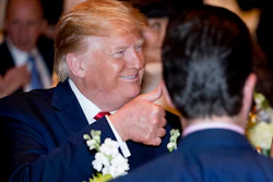 President Donald Trump gives a thumbs-up after arriving for Christmas Eve dinner at Mar-a-lago in Palm Beach, FL on Dec. 24.