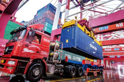 A worker waits to transport containers at the container port in Qingdao in eastern China's Shandong province on Tuesday, Jan. 14.