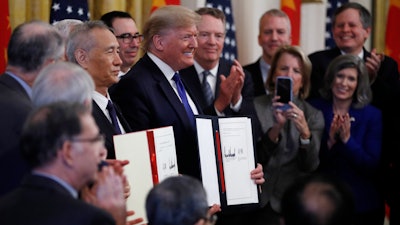 President Donald Trump and Chinese Vice Premier Liu He hold the U.S. China Trade Agreement after signing it in the East Room of the White House on Wednesday, Jan. 15 in Washington.