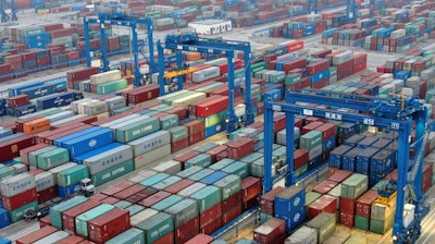 In this Jan. 14 photo, shipping containers are stacked at a dockyard on the Yangtze River in Nantong in eastern China's Jiangsu Province.