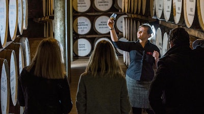 People are guided during a cellar tour of the Dewar’s Distillery in Aberfeldy, the Scottish Highlands, in 2018, where they have produced Scotch whisky since 1898, and offer traditional whisky tastings, and a whisky and chocolate tasting tour.
