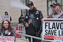 In this Jan. 13 file photo, Matthew Elliot, center, and other supporters of flavored vaping products protest at the state house in Trenton, NJ.