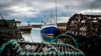 In this Jan. 28 photo, a fishing vessel is docked at Kilkeel harbor in Northern Ireland. The United Kingdom and the European Union are parting ways on Friday and one of the first issues to address is what will happen to the fishing grounds they shared.