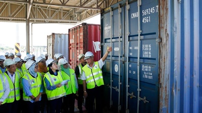Malaysia's Environment Minister Yeo Bee Yin, third from left, inspects a container with plastic waste at a port in Butterworth, Malaysia, Monday, Jan. 20, 2020. Malaysia has sent back 150 containers of plastic waste to 13 mainly rich countries since the third quarter last year, with the environment minster warning on Monday that those who want to make the country a rubbish bin of the world can “dream on.”