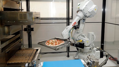 In this Aug. 29, 2016, file photo, a robot places a pizza into an oven at Zume Pizza in Mountain View, Calif. It has not been a good week for robots in the San Francisco Bay Area. A Silicon Valley company that used robots to make its pizzas closed this week and three coffee shops in downtown San Francisco that used robots as baristas also shuttered.