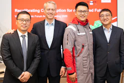 Coca-Cola Chairman and CEO James Quincey (center left), JD Logistics CEO Zhenhui Wang (far left), JD Retail CEO Lei Xu (far right) took a group photo with a JD staff member wearing a uniform made of recycled PET (rPET) materials co-created.
