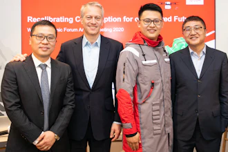 Coca-Cola Chairman and CEO James Quincey (center left), JD Logistics CEO Zhenhui Wang (far left), JD Retail CEO Lei Xu (far right) took a group photo with a JD staff member wearing a uniform made of recycled PET (rPET) materials co-created.