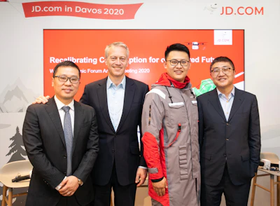 Coca-Cola Chairman and CEO James Quincey (center left), JD Logistics CEO Zhenhui Wang (far left), JD Retail CEO Lei Xu (far right) took a group photo with a JD staff member wearing a uniform made of recycled PET (rPET) materials co-created.