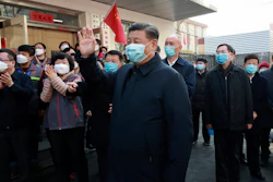 In this photo released by Xinhua News Agency, Chinese President Xi Jinping, centre, wearing a protective face mask waves as he inspects the novel coronavirus pneumonia prevention and control work at a neighbourhoods in Beijing on Monday, Feb. 10. China reported a rise in new virus cases on Monday, possibly denting optimism that its disease control measures like isolating major cities might be working, while Japan reported dozens of new cases aboard a quarantined cruise ship.