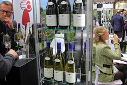 Wine fair goers taste wines of the Burgundy region in Paris on Monday, Feb. 10. Two thousand winemakers - including giant Moet-Hennessy - are wooing some 30,000 French and international visitors at the Vinexpo fair through Wednesday with a renewed focus on ecology and sustainability as well as tech innovation like robots.