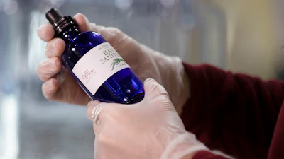 Logan Snyder bottles hand sanitizer made at the Eight Oaks Farm Distillery in New Tripoli, PA.