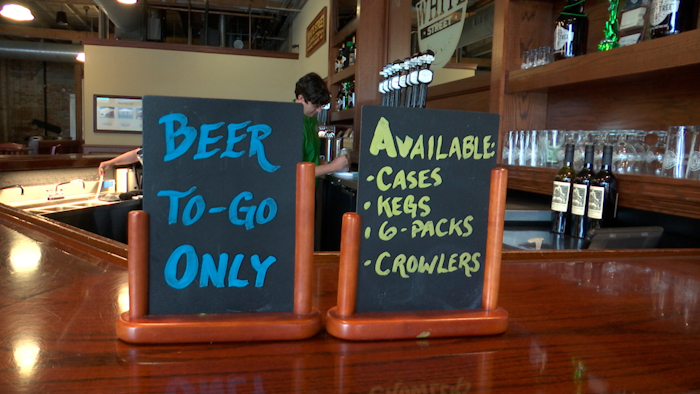 An employee at White Street Brewing Company in Wake Forest, NC fills a 'crowler' can of beer on Tuesday, March 17. With bars ordered close due to coronavirus, brewers are making sure their customers can enjoy some fresh suds.