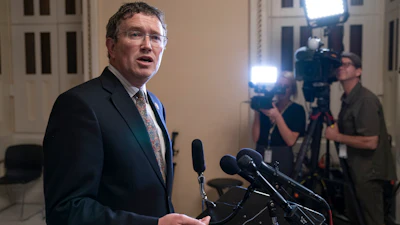 In this May 28, 2019 file photo, Rep. Thomas Massie, R-Ky., speaks to reporters at the Capitol after he blocked a unanimous consent vote on a long-awaited hurricane disaster aid bill in the chamber. House leaders' plan for swift action on a $2.2 trillion package to ease the coronavirus pandemic's devastating toll on the U.S. economy and health care system ran into complications Friday, March 27 as the maverick conservative threatened to delay passage until most lawmakers return to Washington for a vote. Party leaders had hoped to pass the measure by voice vote without lawmakers having to take the risk of traveling to Washington.