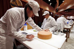 Judge Douwe Dijkstra pulls out a piece of Appenzeller cheese at the biennial World Championship Cheese Contest on Tuesday, March 3 at the Monona Terrace Convention Center in Madison, WI. It's the largest technical cheese, butter and yogurt competition in the world. This year the competition had a record 3,667 entries from 26 nations.