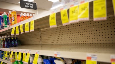 In this March 4, 2020 file photo, shelves where disinfectant wipes and sprays are usually displayed sit empty in a pharmacy in Providence, RI as confirmed cases of the coronavirus rise in the US. Legions of nervous hoarders are stocking up on canned goods, frozen dinners, toilet paper, and cleaning products. Such hoarding that's expected to last for weeks has created big challenges for discounters and grocery stores as well as food delivery services.
