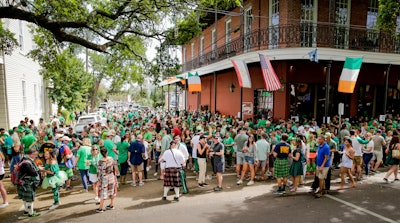 Revelers celebrate St. Patrick's Day on Saturday, March 14 during an unofficial gathering at Tracey's Original Irish Channel Bar in New Orleans.