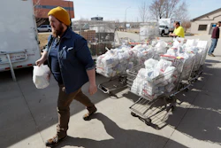 In this Tuesday, March 17 photo, Patrick Minor loads food onto a delivery truck at the Des Moines Area Religious Council food pantry in Des Moines, IA. With the new coronavirus leaving many people at least temporarily out of work, food banks and pantries across the U.S. are scrambling to meet an expected surge in demand, even as older volunteers have been told to stay home and calls for social distancing have complicated efforts to package and distribute food.