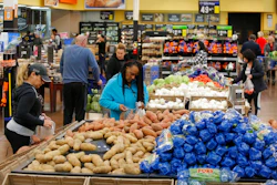In this Nov. 27, 2019, file photo people shop for food the day before the Thanksgiving holiday at a Walmart Supercenter in Las Vegas. U.S. consumer prices increased slightly last month, driven higher by more expensive food. The Labor Department said Wednesday, March 11, 2020, that the consumer price index ticked up 0.1% last month, matching its January increase.