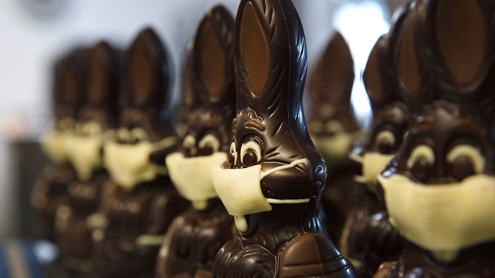 In this photo taken on Wednesday, April 8, chocolate rabbits with face masks are lined up at the Cocoatree chocolate shop in Lonzee, Belgium. As all non-essential shops in Belgium have been closed due to the outbreak of COVID-19, many chocolatiers have had to resort to online sales, home delivery or pick up on site.