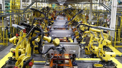 In this Sept. 27, 2018 file photo, robots weld the bed of a 2018 Ford F-150 truck on the assembly line at the Ford Rouge assembly plant in Dearborn, MI.