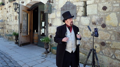 In this photo taken Wednesday, April 1, George Webber, dressed as 'The Count' Agoston Haraszthy, leads a virtual online tasting and tour of the historic Buena Vista Winery in Sonoma, CA. The winery is the state's oldest commercial winery dating to 1857. Wineries that want to stay viable and connected to their customers during the coronavirus pandemic are harnessing platforms such as Facebook Live to offer virtual wine experiences.