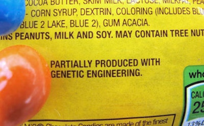 In this April 8, 2016 photo, a new disclosure statement is displayed on a package of Peanut M&Ms candy in Montpelier, Vt., saying they are 'Partially produced with genetic engineering.' Vermont is set to become the first state in the country on July 1 to require the labeling of foods made with genetically modified ingredients.
