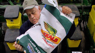 In this April 4, file 2011 photo, central Illinois corn and soybean farmer Gary Niemeyer readies his DEKALB seed corn for spring planting at his farm near Auburn, Ill. German drug and chemicals company Bayer AG announced Monday, May 23, 2016 that it has made a US$ 62 billion offer to buy U.S.-based crops and seeds specialist Monsanto. The proposed combination would create a giant seed and farm chemical company with a strong presence in the U.S., Europe and Asia.