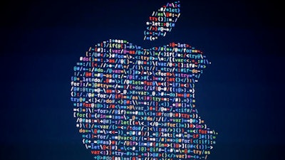 In this June 13, 2016 file photo, The Apple logo is shown on a screen at the Apple Worldwide Developers Conference in the Bill Graham Civic Auditorium, in San Francisco. Google, Apple and other tech giants expressed dismay over an executive order on immigration from President Donald Trump that bars nationals of seven Muslim-majority countries from entering the U.S.