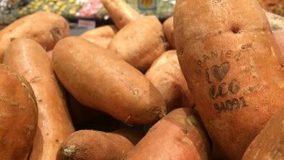 In this photo taken on Tuesday Jan. 31, 2017, laser branded sweet potatoes are displayed at the ICA Kvantum supermarket in Malmo, Sweden. Something high-tech is happening in the produce aisle at some Swedish supermarkets, where laser marks have replaced labels on the organic avocados and sweet potatoes.