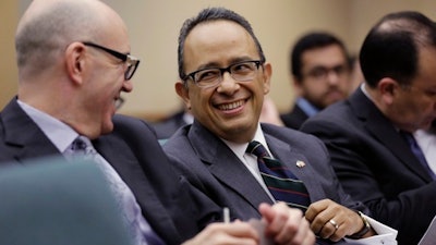 Carlos Gonzalez Gutierrez, center, Mexico's consul general in Austin, waits to give testimony to the Committee on International Trade and Intergovernmental Affairs at the Texas Capitol, Monday, March 6, 2017, in Austin, Texas. Officials from Mexico and Texas are urging the state's lawmakers to defend the North American Free Trade Agreement against President Donald Trump's administration, which has been wary of it.