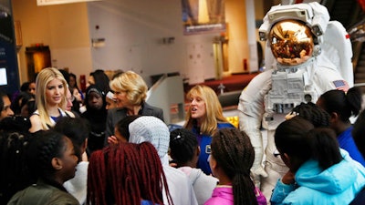 Ivanka Trump, left, Education Secretary Betsy DeVos, center, listens as NASA Astronaut Kay Hire speaks to female students at the Smithsonian's National Air and Space Museum in Washington, Tuesday, March 28, 2017, to celebrate Women's History Month.