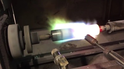 To prime the stainless steel plunger barrel for coating, the plunger is mounted onto a coating lathe, where the spray gun preheats it to over 400°F.